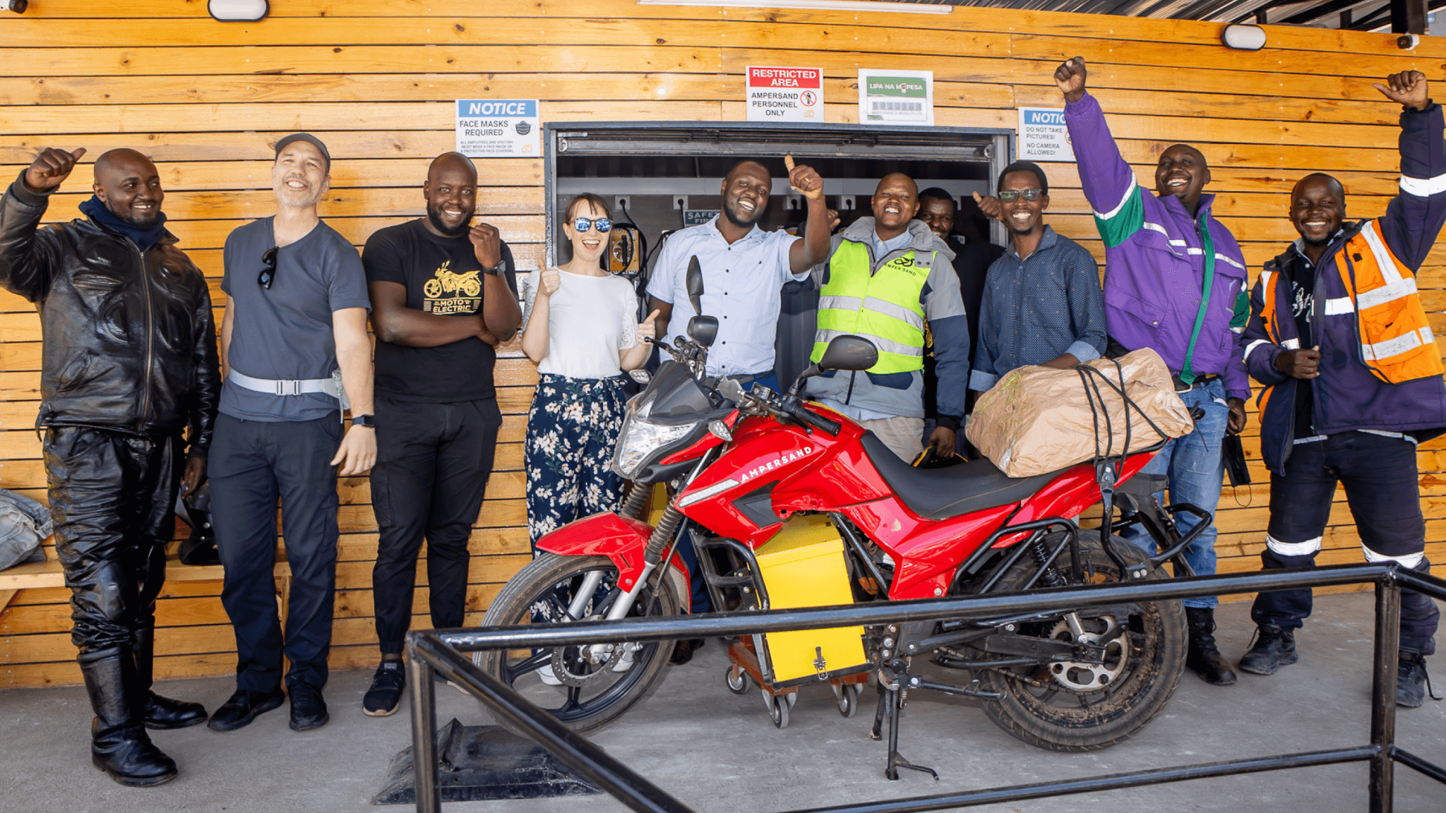 People gathered around an electric motorcycle in Nairobi, Kenya