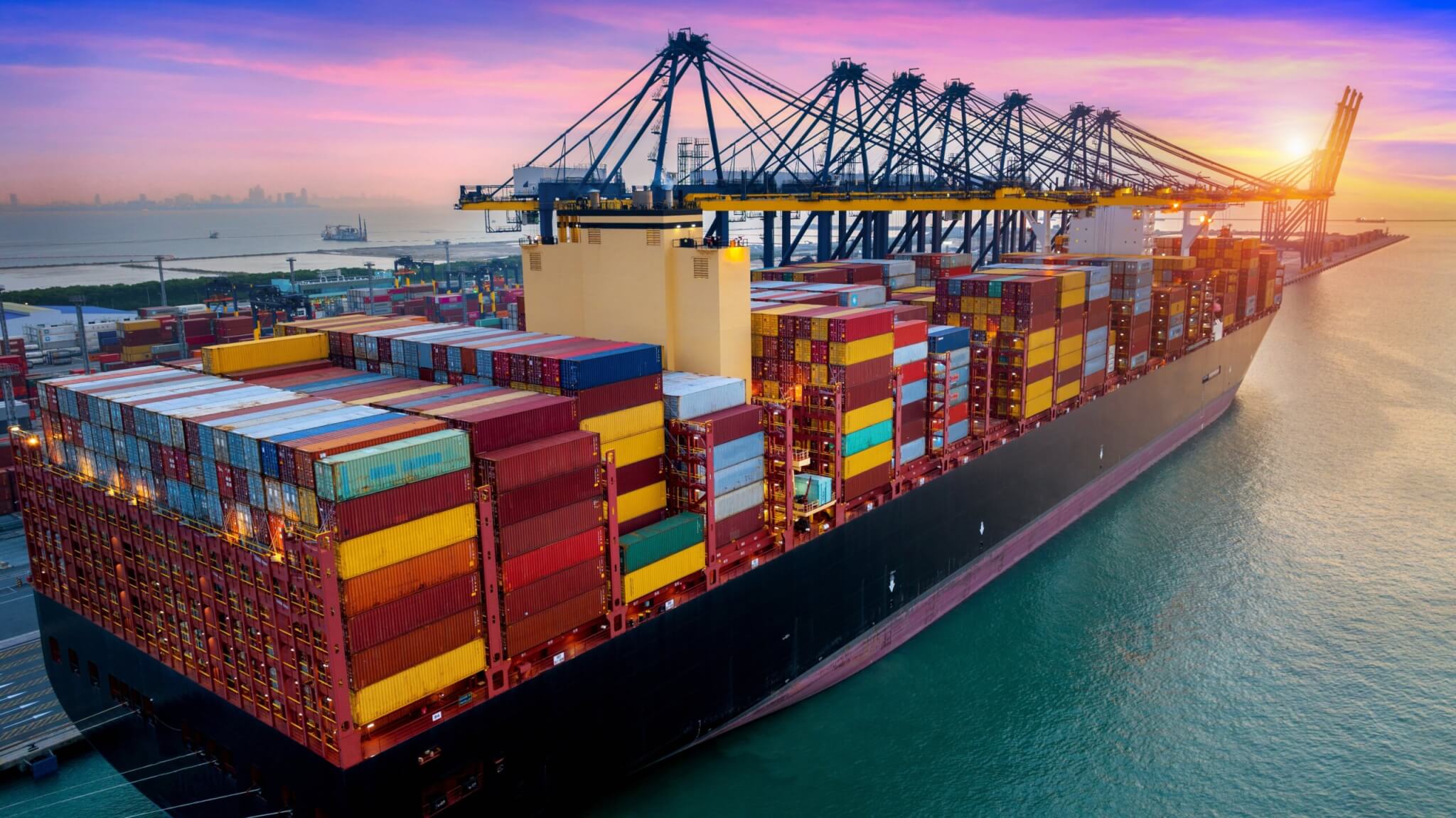 Aerial view of cargo ship and cargo container in harbor.